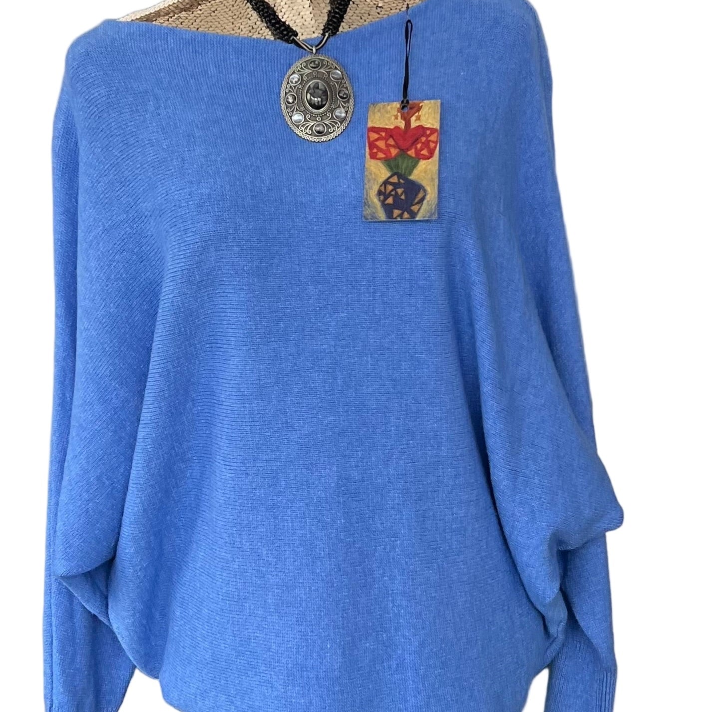Denim blue jumper with elegant pearl detailing on the back