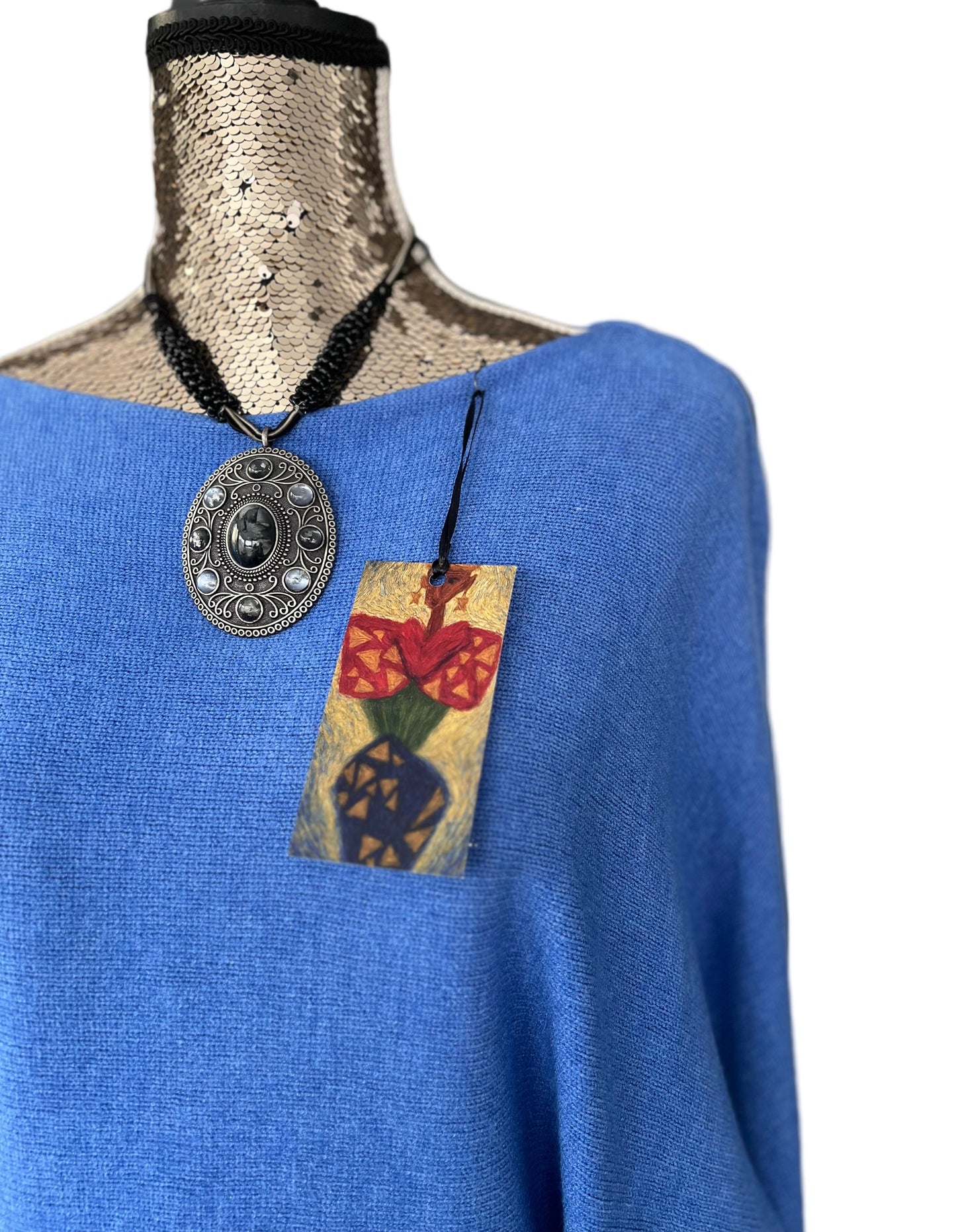 Denim blue jumper with elegant pearl detailing on the back