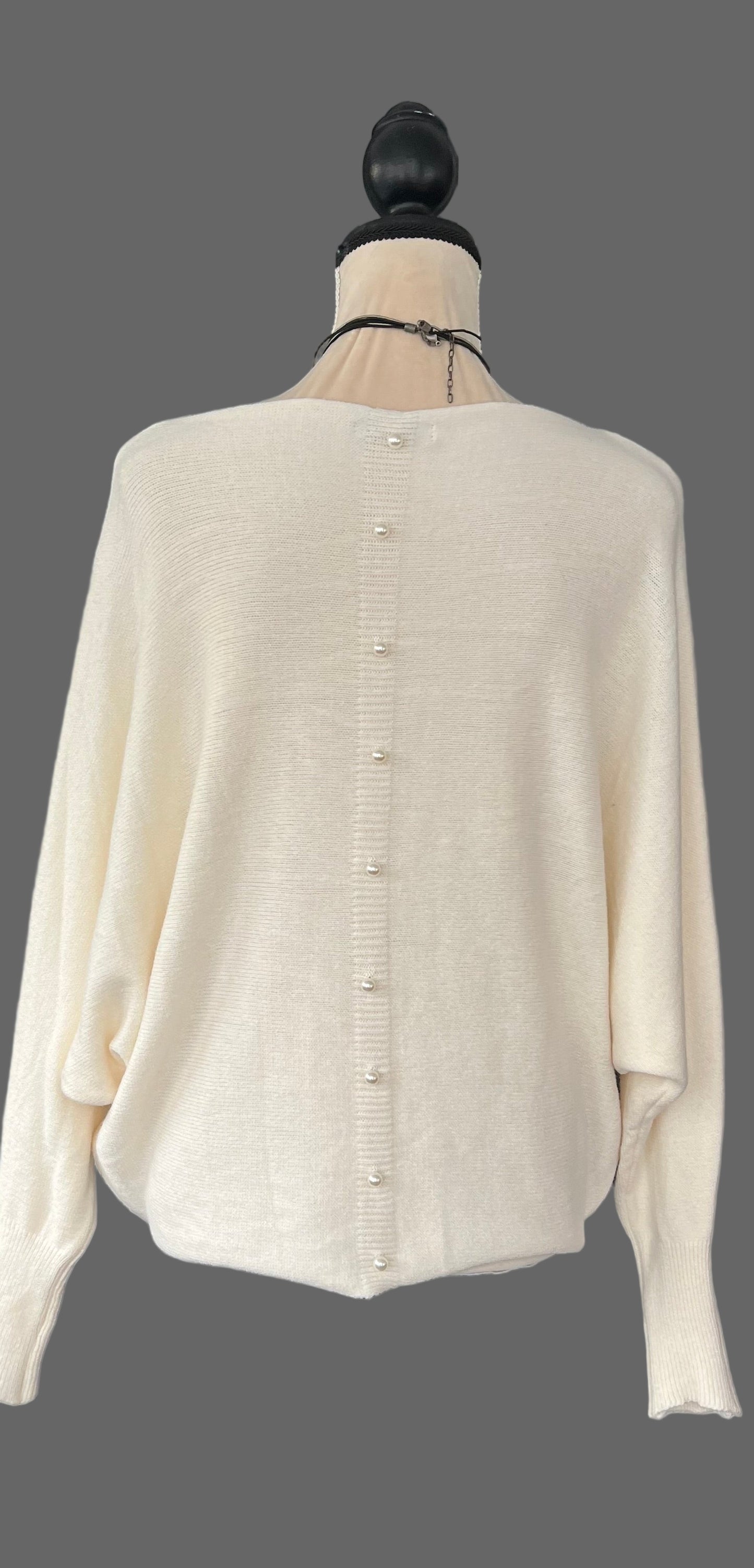 Cream jumper with elegant pearl detailing on the back