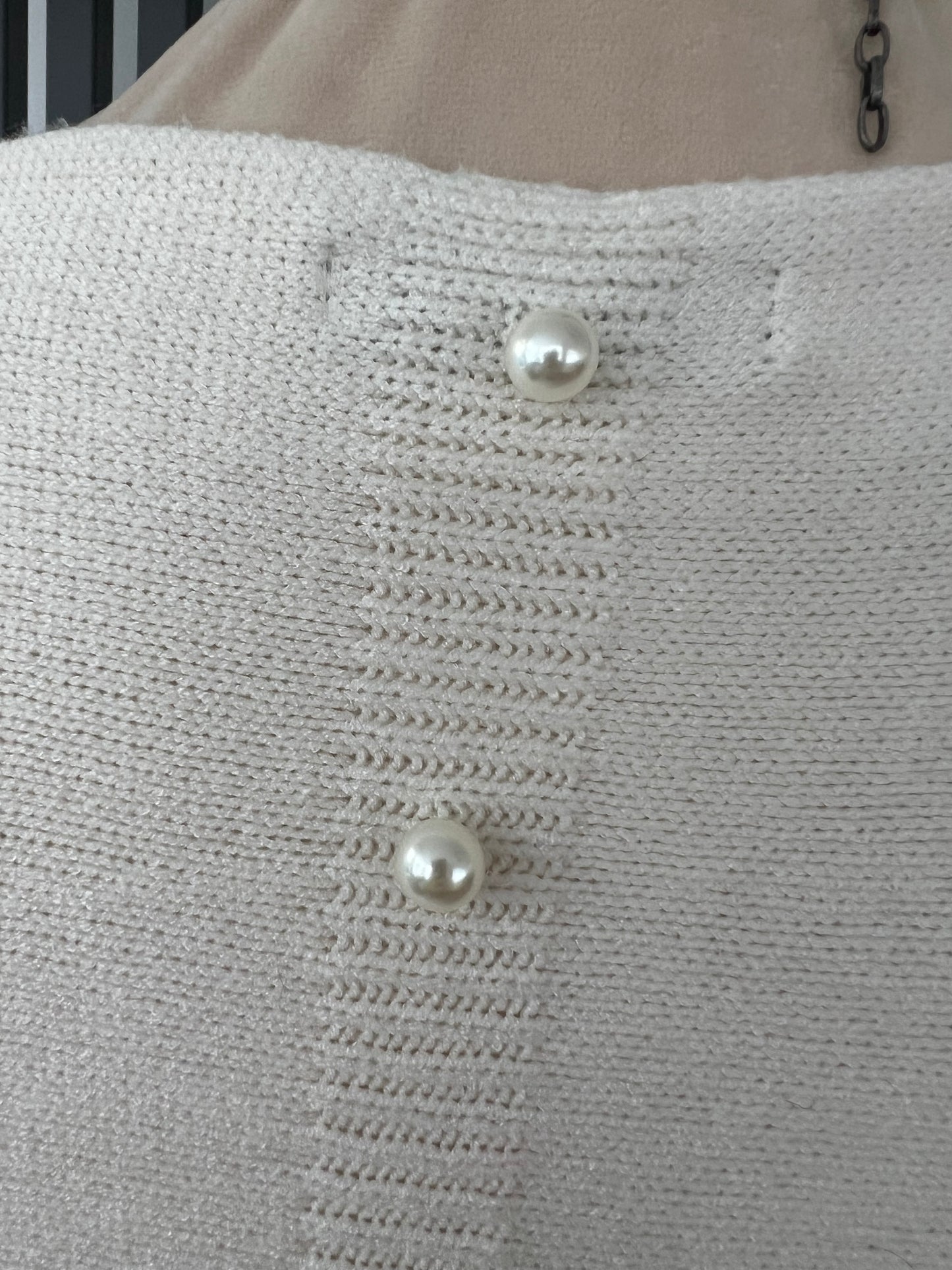 Cream jumper with elegant pearl detailing on the back