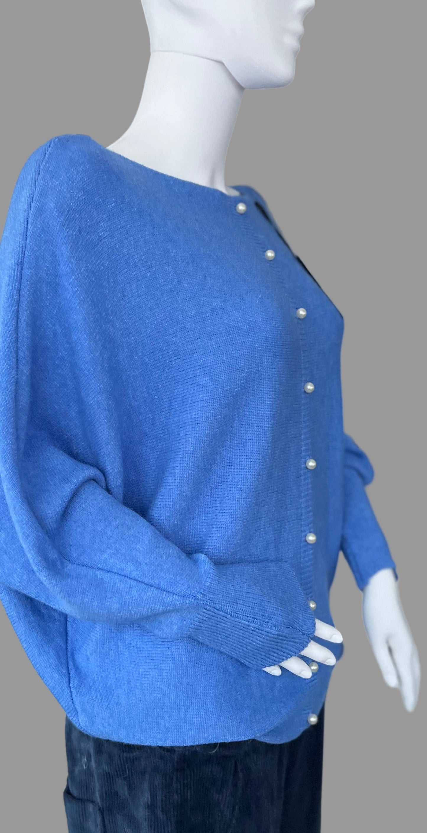 Denim blue jumper with elegant pearl detailing on the back