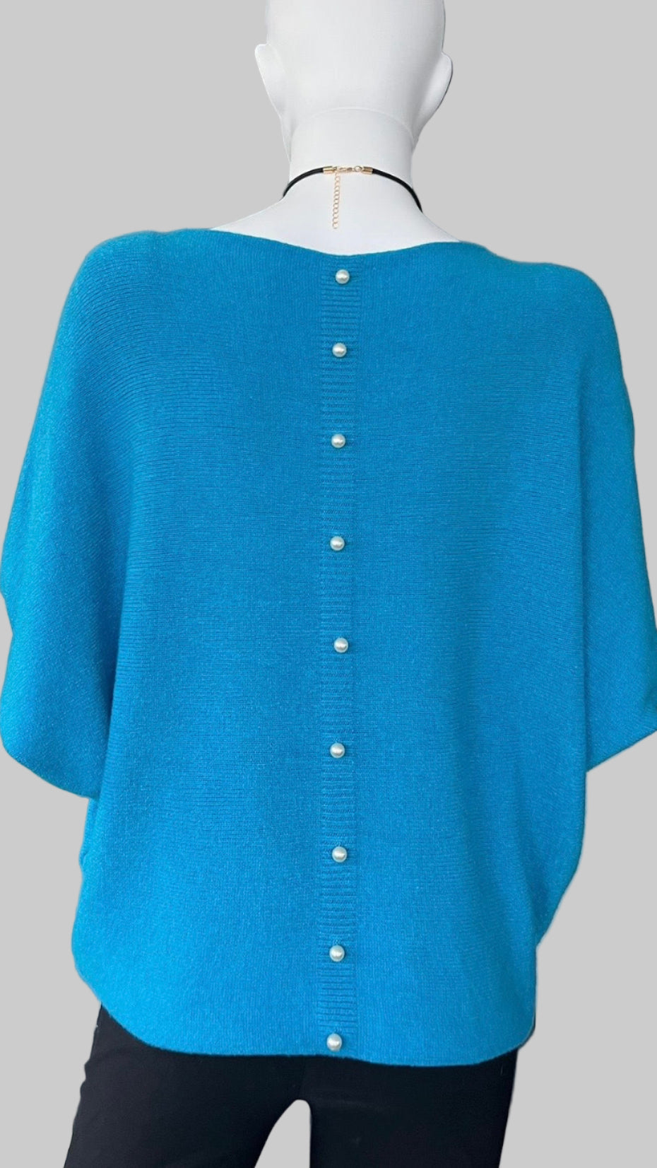 Turquoise jumper with elegant pearl detailing on the back