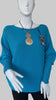 Turquoise jumper with elegant pearl detailing on the back