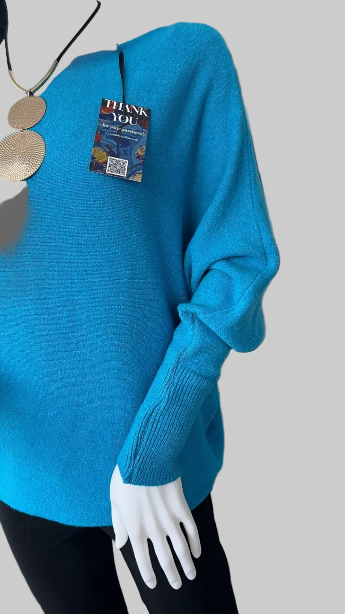 Turquoise jumper with elegant pearl detailing on the back