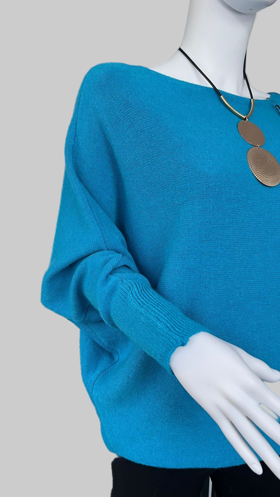 Turquoise jumper with elegant pearl detailing on the back