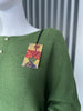Khaki green jumper with elegant pearl detailing on the back