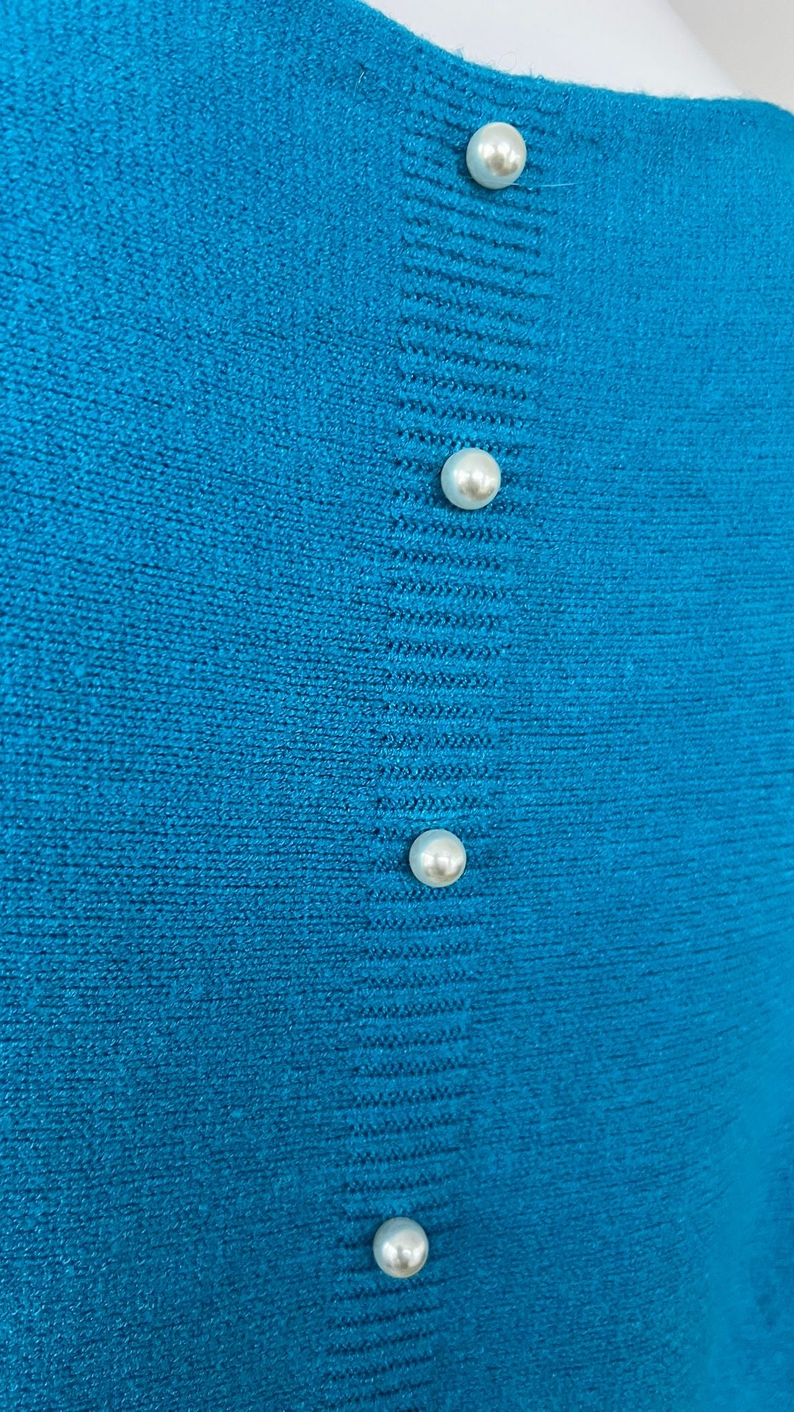 Turquoise jumper with elegant pearl detailing on the back