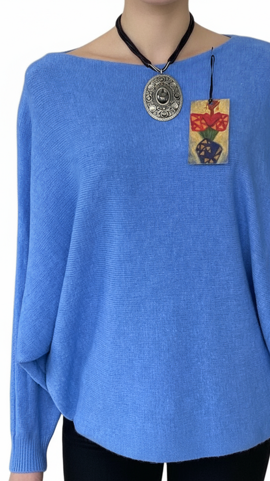 Denim blue jumper with elegant pearl detailing on the back